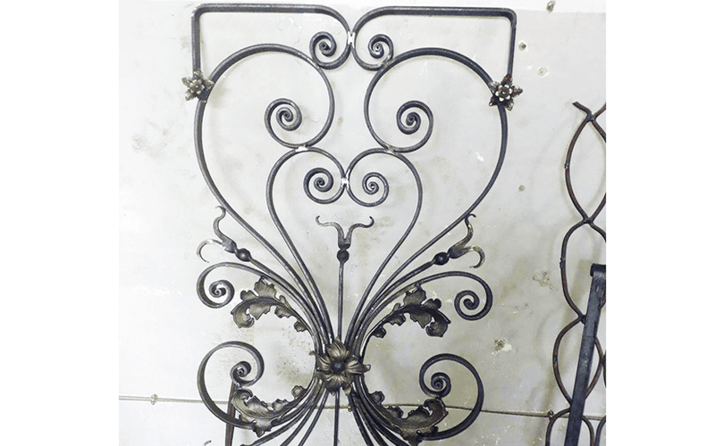 Load image into Gallery viewer, Ornamental ironwork panel with scrolls and decorative details formed on the Nargesa MT150A
