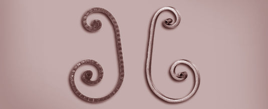 Two ornamental wrought iron scrolls with forged snail ends produced on the Nargesa PC16