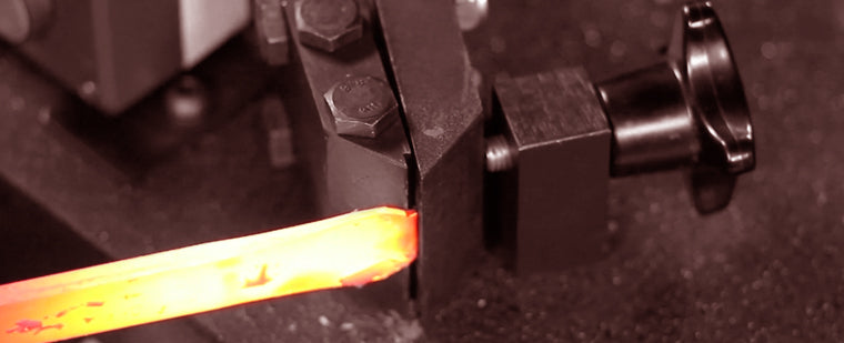 Load image into Gallery viewer, Close-up of a red-hot bar being formed in the Nargesa PC16 hydraulic forging tooling
