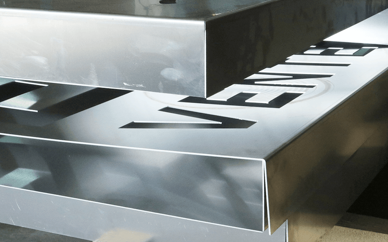 Load image into Gallery viewer, Close-up of sharp, clean bends on stainless steel panels formed on the Nargesa MP3160CNC
